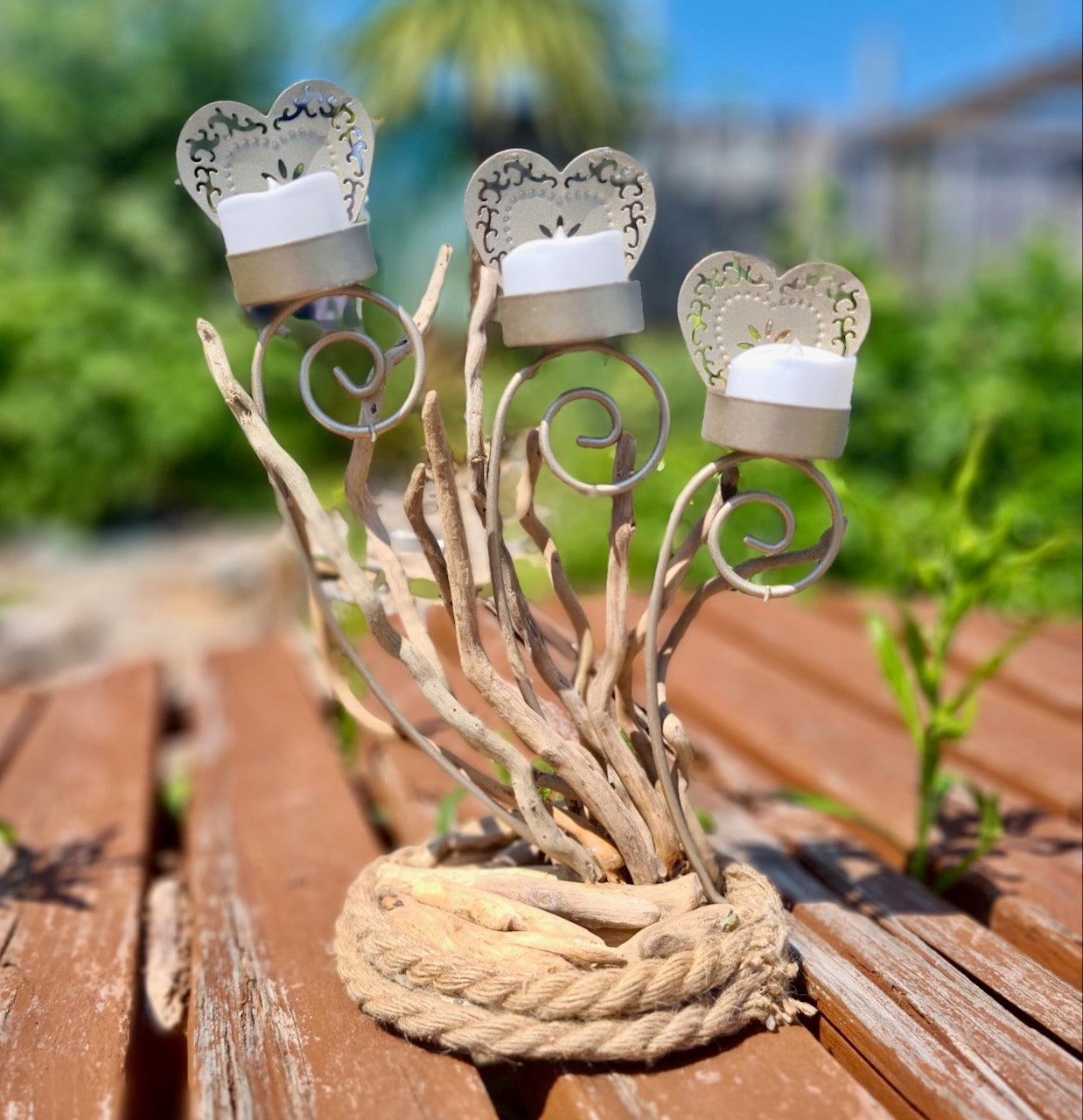 candle holder made out of driftwood and rope